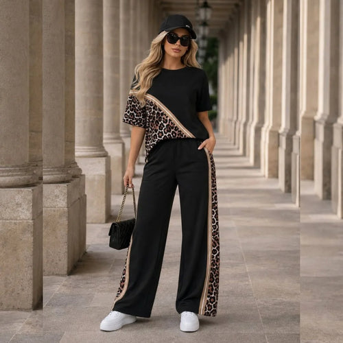 Aitana conjunto negro de dos piezas con blusa de manga corta y detalles animal print, pantalón de tiro alto y pierna amplia con franjas laterales animal print | MATTEA